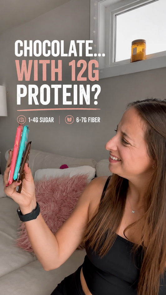 High protein chocolate bars with 12g protein and low sugar held by woman in lifestyle image for article about dark chocolate protein content